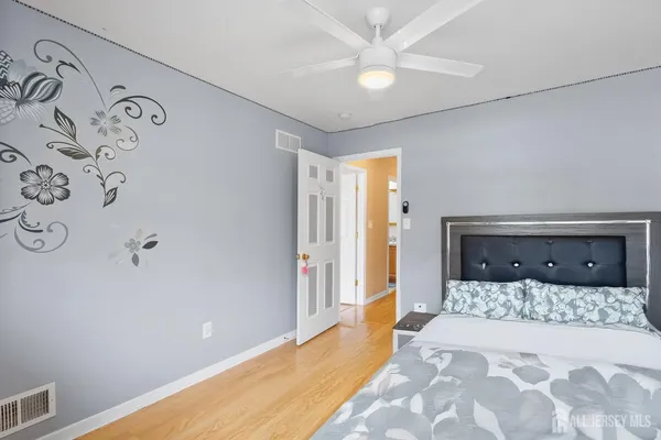 a bedroom with a large bed and a chandelier