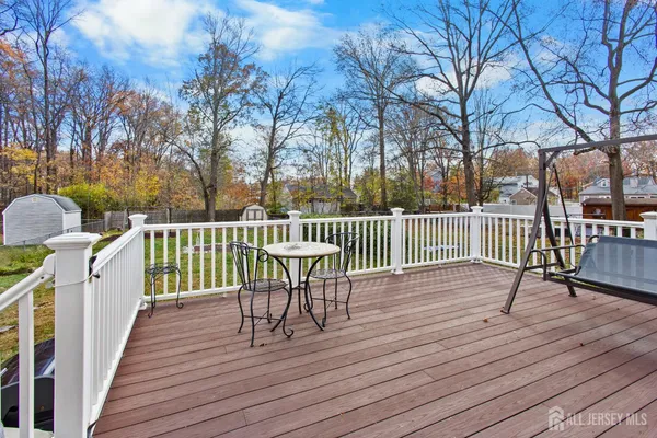 a view of a deck with table and chairs and wooden floor