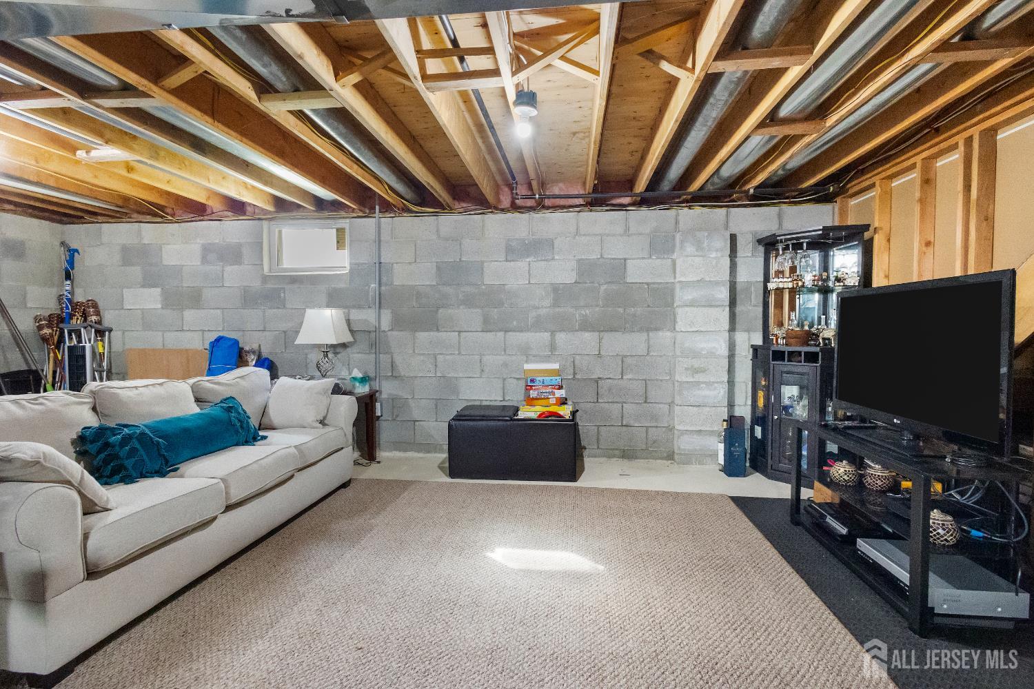 1740 Holly Road North Brunswick, NJ 08902 - Photo 28 of 32 a living room with furniture and a flat screen tv