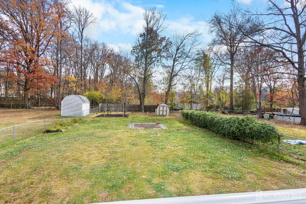 a backyard of apartments with large trees