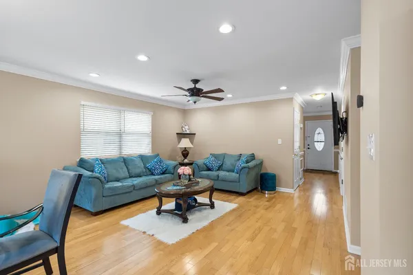 a living room with furniture and a wooden floor