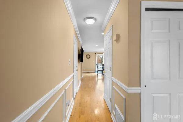 a view of hallway with wooden floor