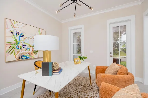 a view of a dining room with furniture and a potted plant