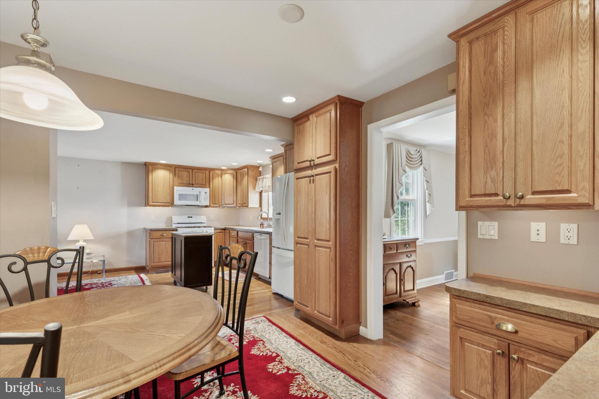 1500 Allen Road Oreland, PA 19075 - Photo 12 of 49 a kitchen with refrigerator cabinets dining table and chairs