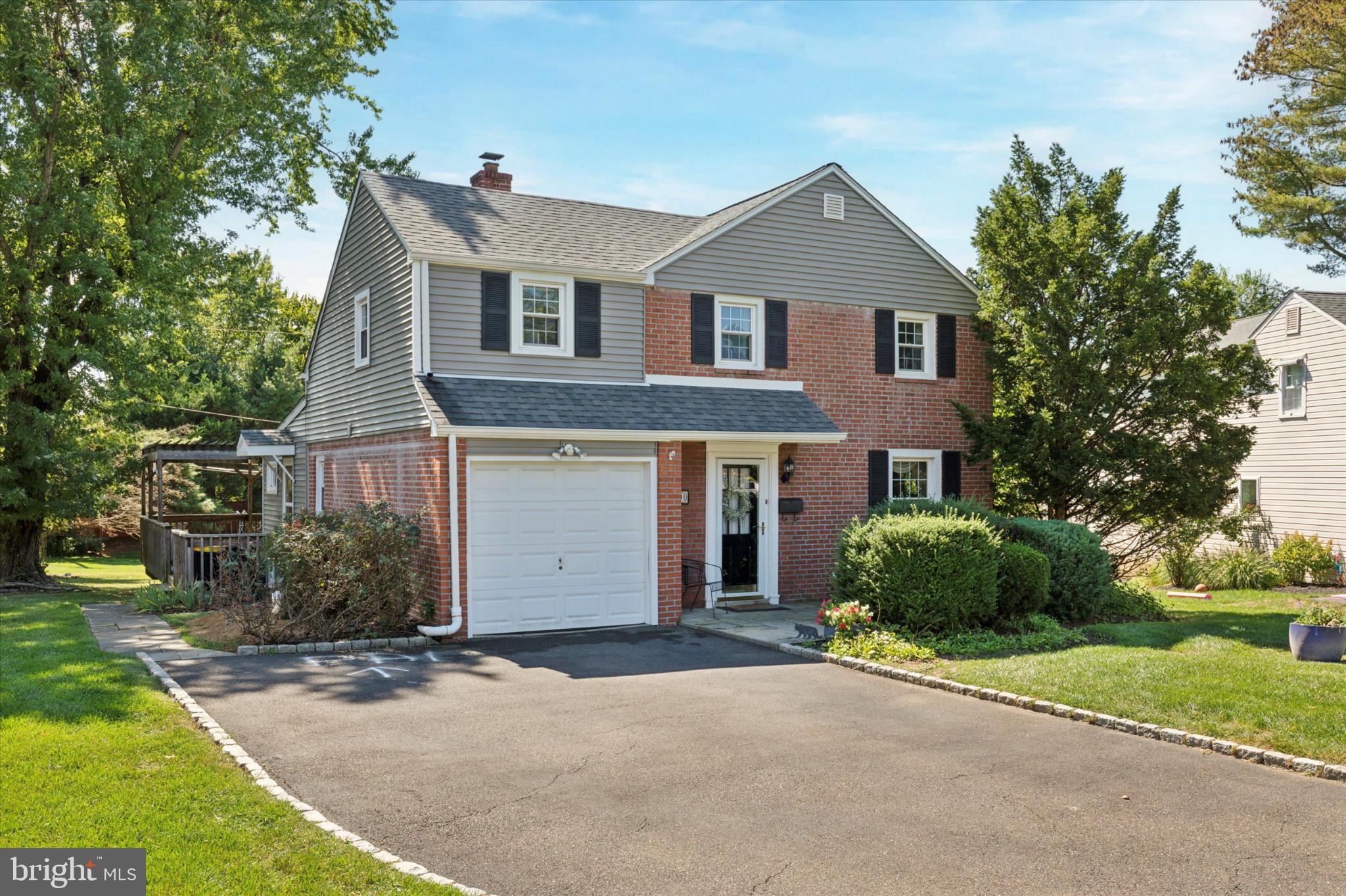 1500 Allen Road Oreland, PA 19075 - Photo 2 of 49 a front view of a house with a yard and garage