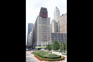 6 North Michigan Avenue, Unit 606 Chicago, IL 60602 - Photo 1 of 1 a view of a tall building next to a yard