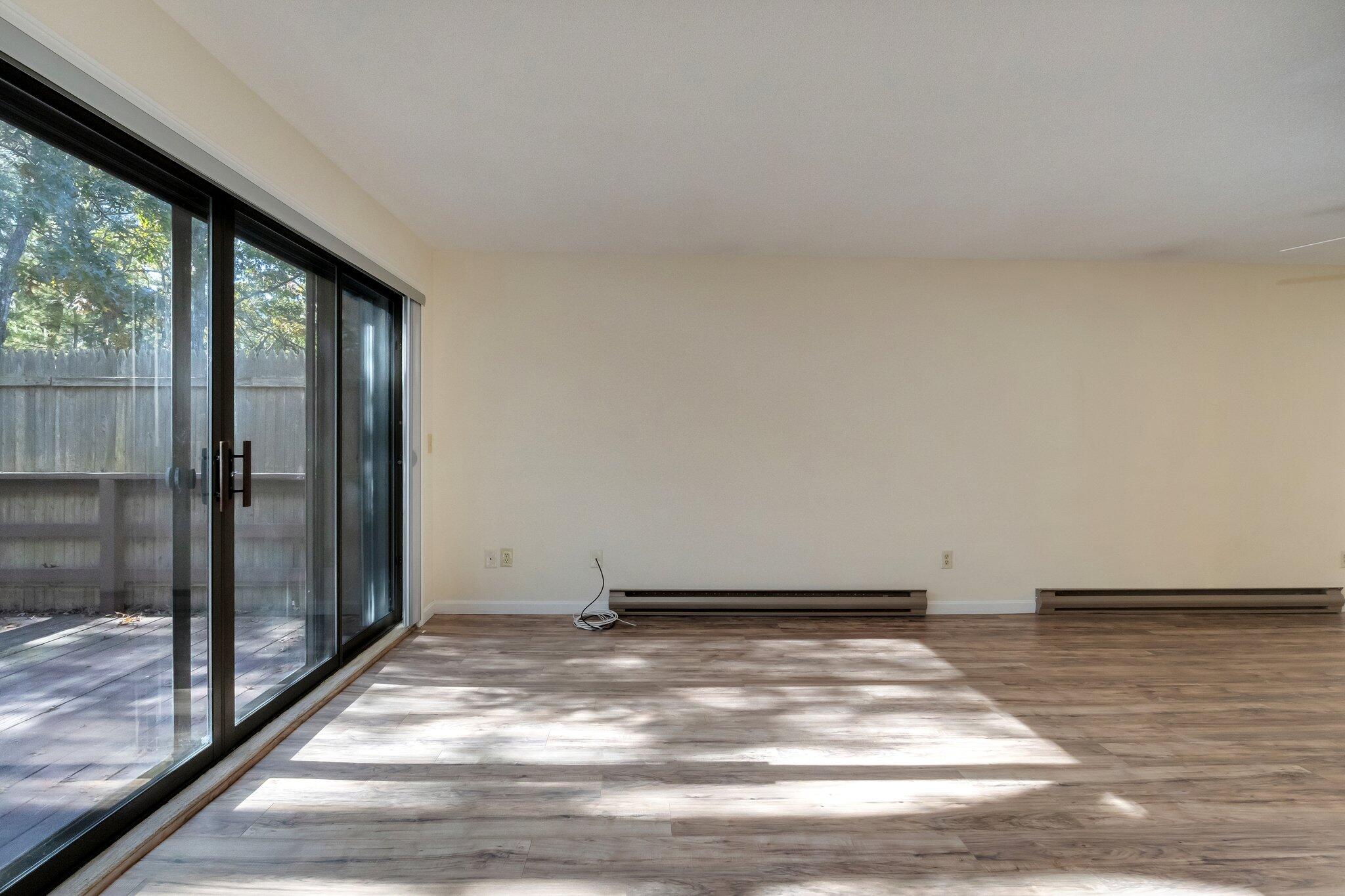 81 Round House Road Bourne, MA 02532 - Photo 11 of 32 a view of a livingroom with wooden floor and a window