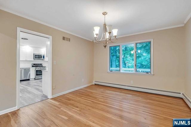 32 Rock Road Englewood Cliffs, NJ 07632 - Photo 10 of 30 an empty room with wooden floor chandelier and windows