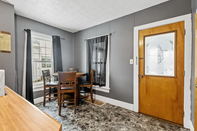 a dining room with wooden floor and a window