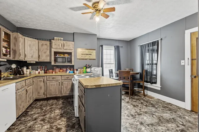 a kitchen with sink cabinets and window