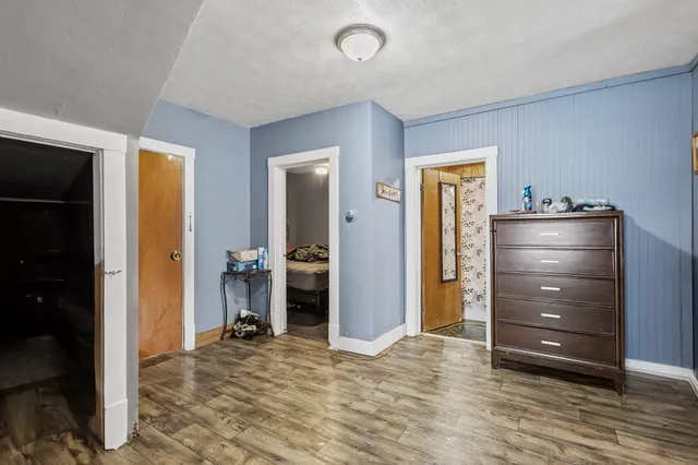 a view of a bedroom with a dresser and mirror