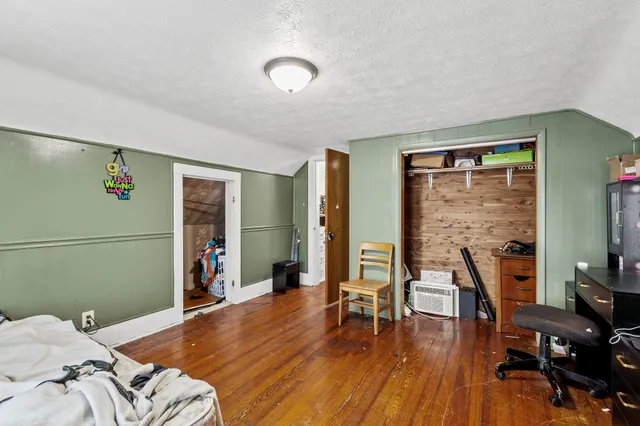 a bedroom with furniture and a wooden floor