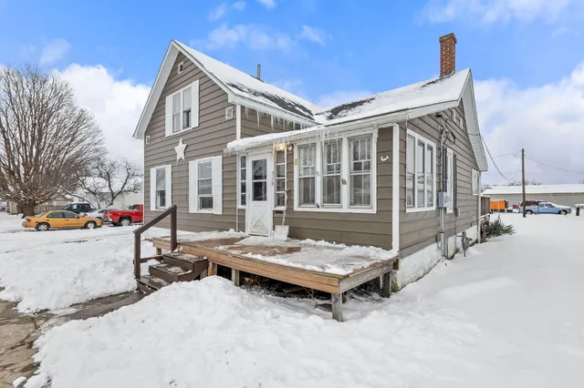 a view of a patio with a table and chairs and potted plants