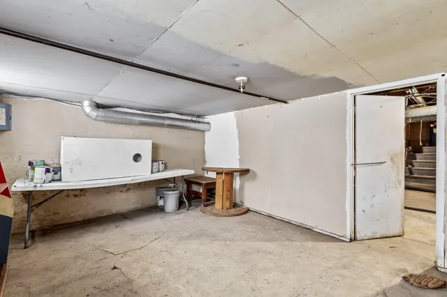 a view of a storage & utility room with two washing machine
