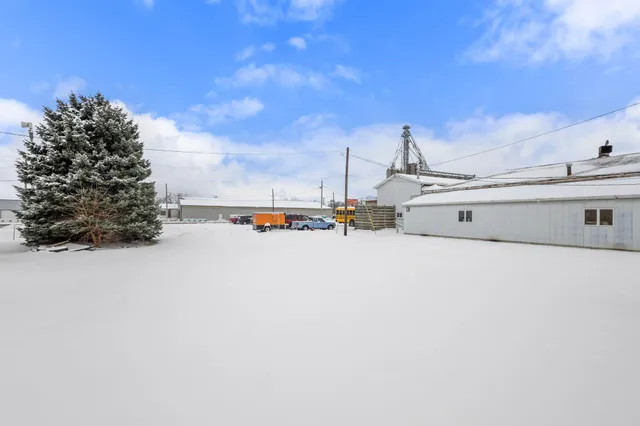 a view of water with a big yard and large trees