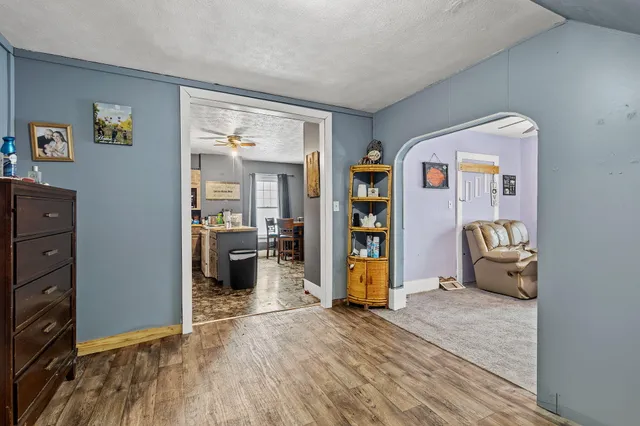 a bedroom with furniture and a wooden floor
