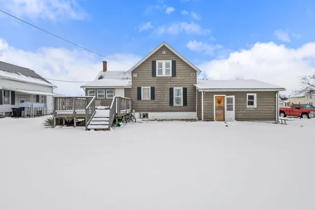 a front view of a house with yard and porch