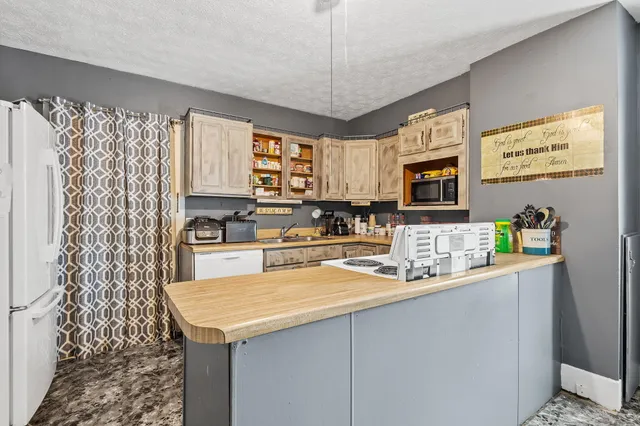 a kitchen with stainless steel appliances granite countertop a sink stove and microwave