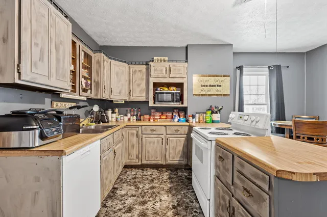 a kitchen with a sink stove and cabinets