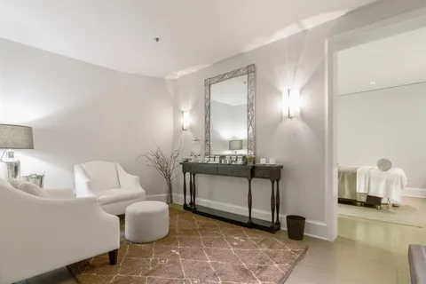 a living room with furniture and floor to ceiling window