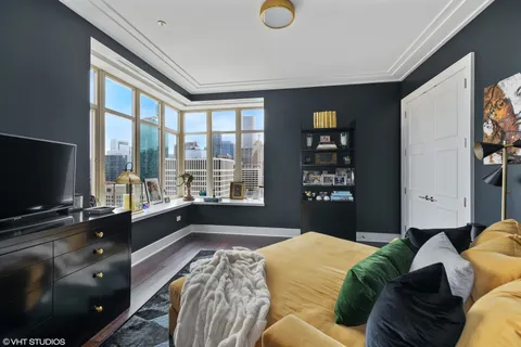 a large kitchen with stainless steel appliances granite countertop a lot of counter space and wooden floor