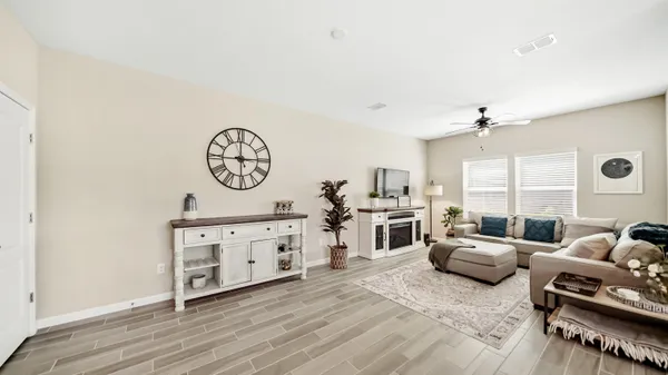 a living room with furniture a fireplace and a window