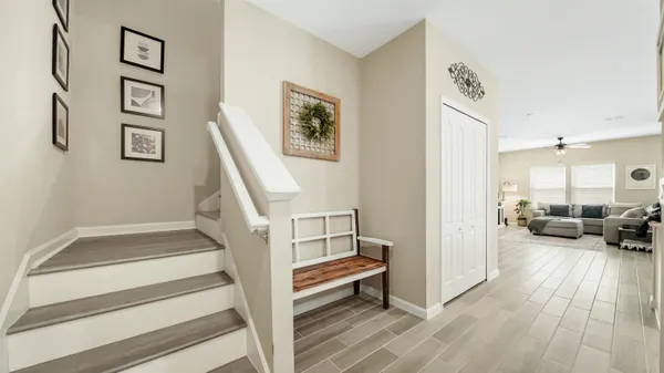 a view of a livingroom with furniture and stairs