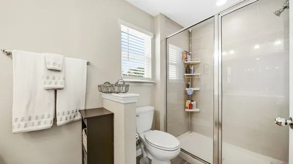 a bathroom with a shower a toilet and a sink