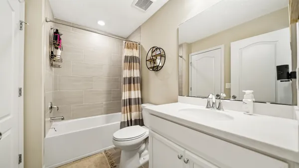 a bathroom with a sink a toilet and a large mirror