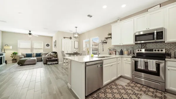 a kitchen with sink a microwave and cabinets