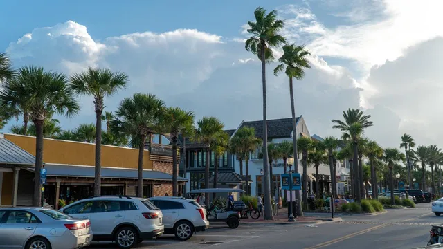a front view of a building with palm trees