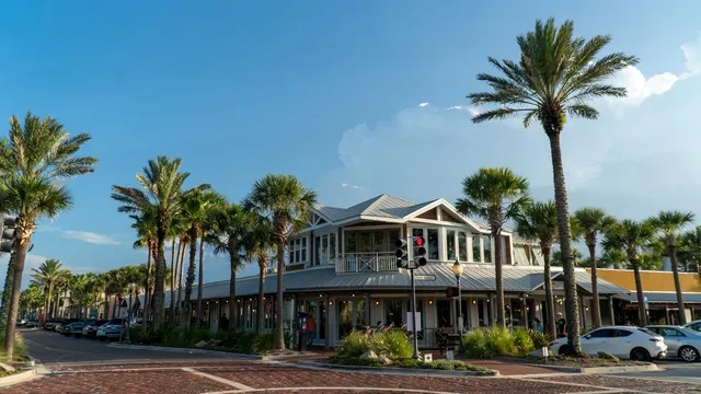 a front view of a building with palm trees
