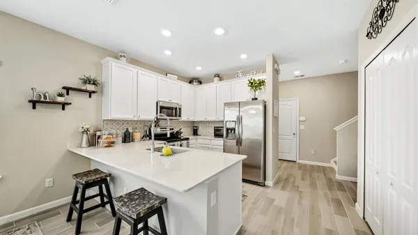 a kitchen with refrigerator and cabinets