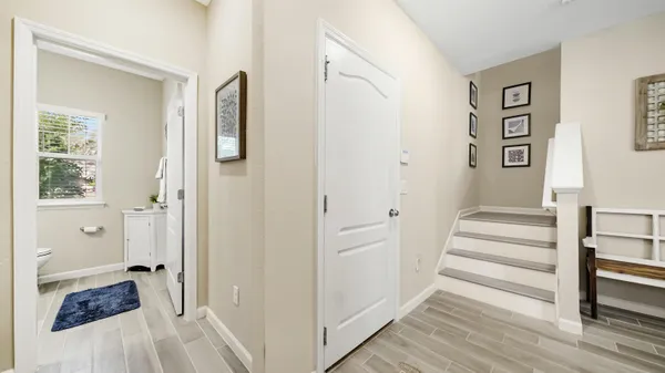 a view of a hallway with wooden floor and entryway