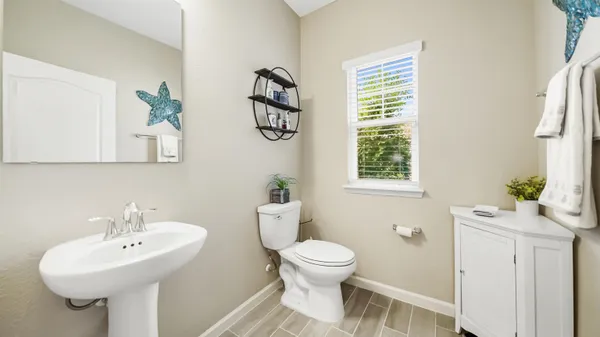 a bathroom with a sink toilet and a mirror