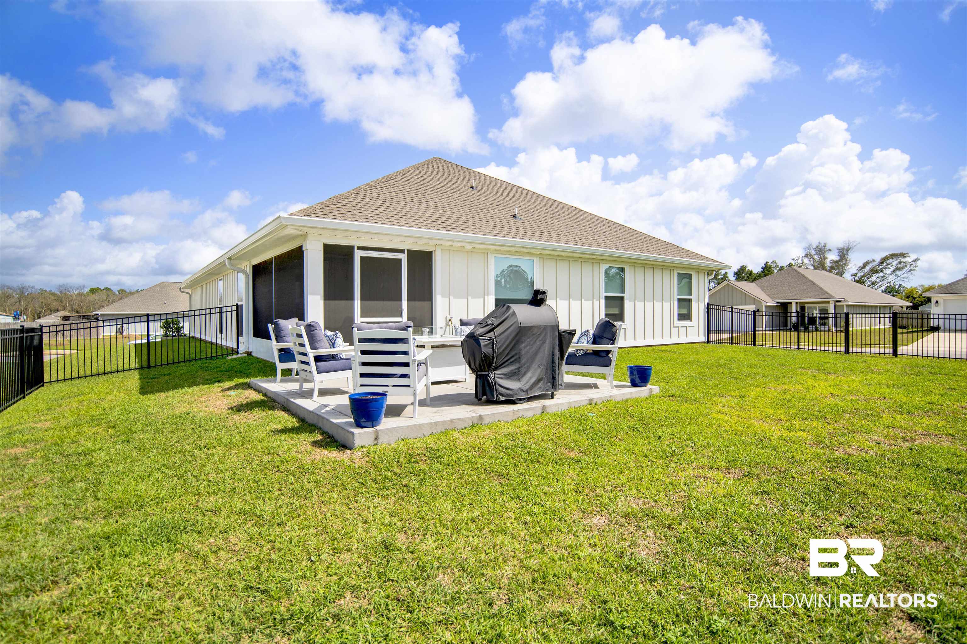 3097 Ingrid Lane Foley, AL 36535 - Photo 33 of 38 Back of house with a yard, a patio area, board and batten siding, and a fenced backyard