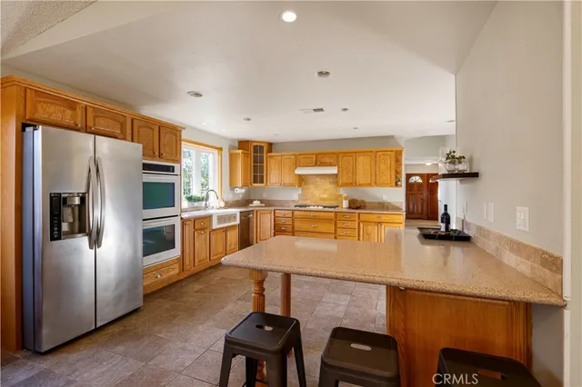a dining room with furniture a chandelier and window