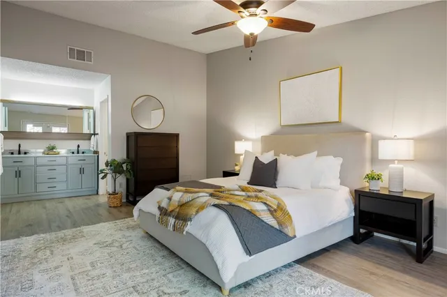 a spacious bathroom with a granite countertop sink and a mirror