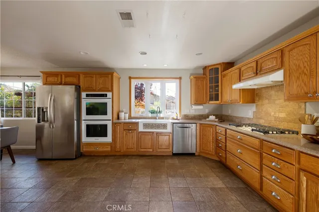 a kitchen with granite countertop a stove and a refrigerator