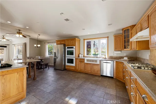 a kitchen with kitchen island a counter space and stainless steel appliances