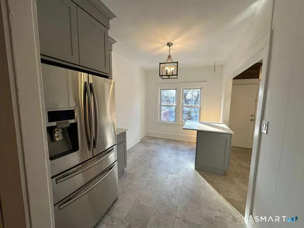 a kitchen with stainless steel appliances a refrigerator and a window