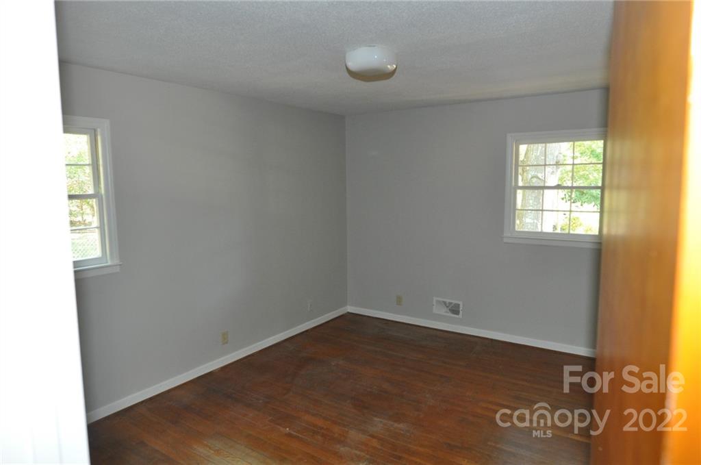 103 Sunset Drive Chester, SC 29706 - Photo 11 of 19 wooden floor in an empty room with a window
