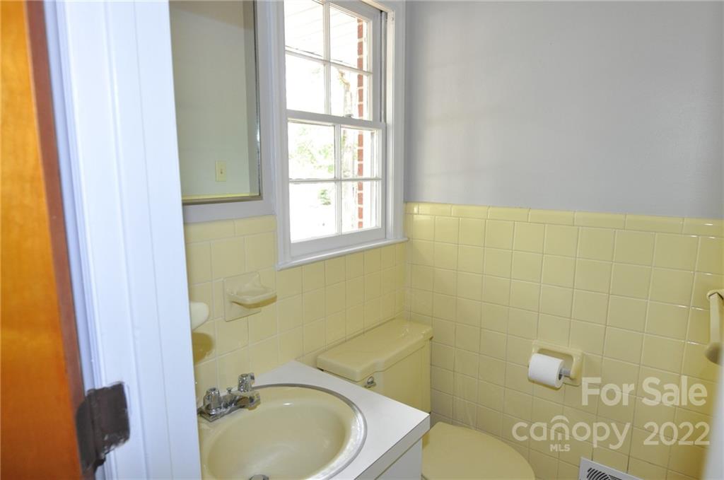 103 Sunset Drive Chester, SC 29706 - Photo 12 of 19 a bathroom with a sink a toilet and a window