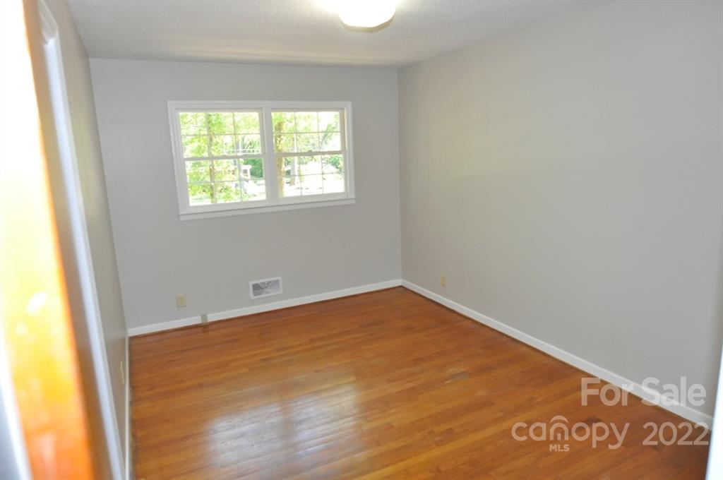 103 Sunset Drive Chester, SC 29706 - Photo 14 of 19 an empty room with wooden floor and windows