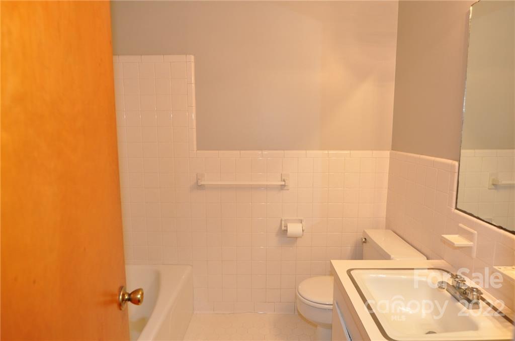 103 Sunset Drive Chester, SC 29706 - Photo 15 of 19 a bathroom with a granite countertop toilet and a sink