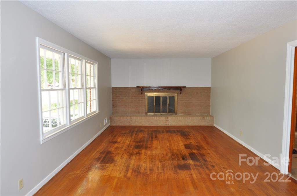 103 Sunset Drive Chester, SC 29706 - Photo 9 of 19 a view of empty room with wooden floor and fan