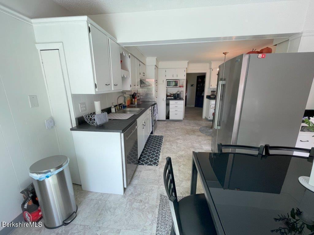 193 South Mountain Road Pittsfield, MA 01201 - Photo 14 of 49 a kitchen with stainless steel appliances granite countertop a sink refrigerator and a stove