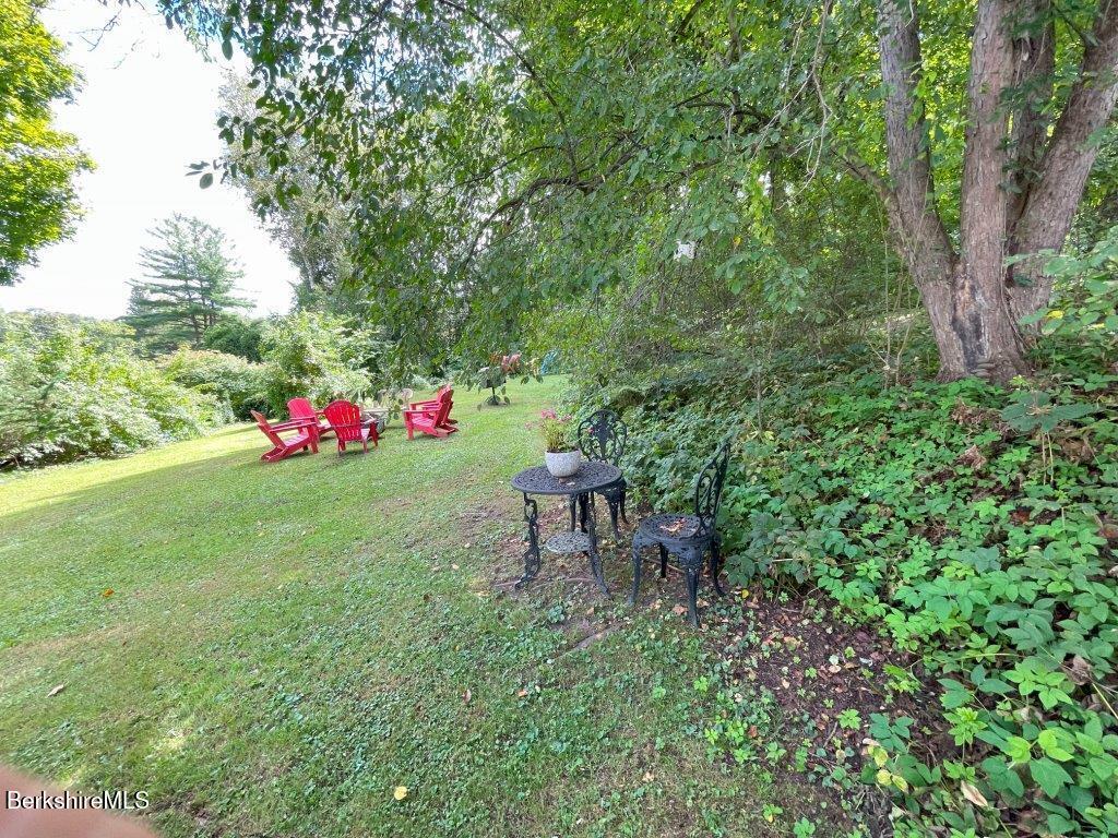 193 South Mountain Road Pittsfield, MA 01201 - Photo 32 of 49 a view of a backyard with table and chairs and potted plants