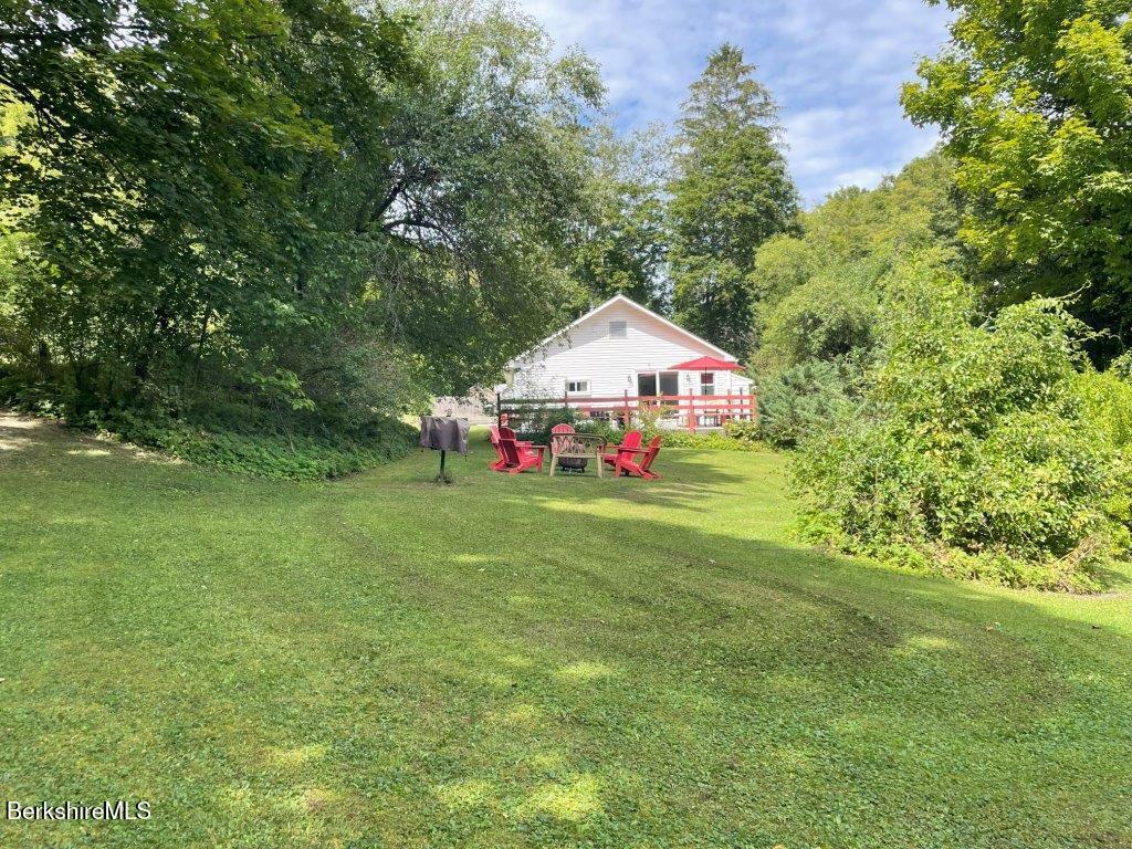 193 South Mountain Road Pittsfield, MA 01201 - Photo 36 of 49 a yellow and red tree sitting in the grass of a house