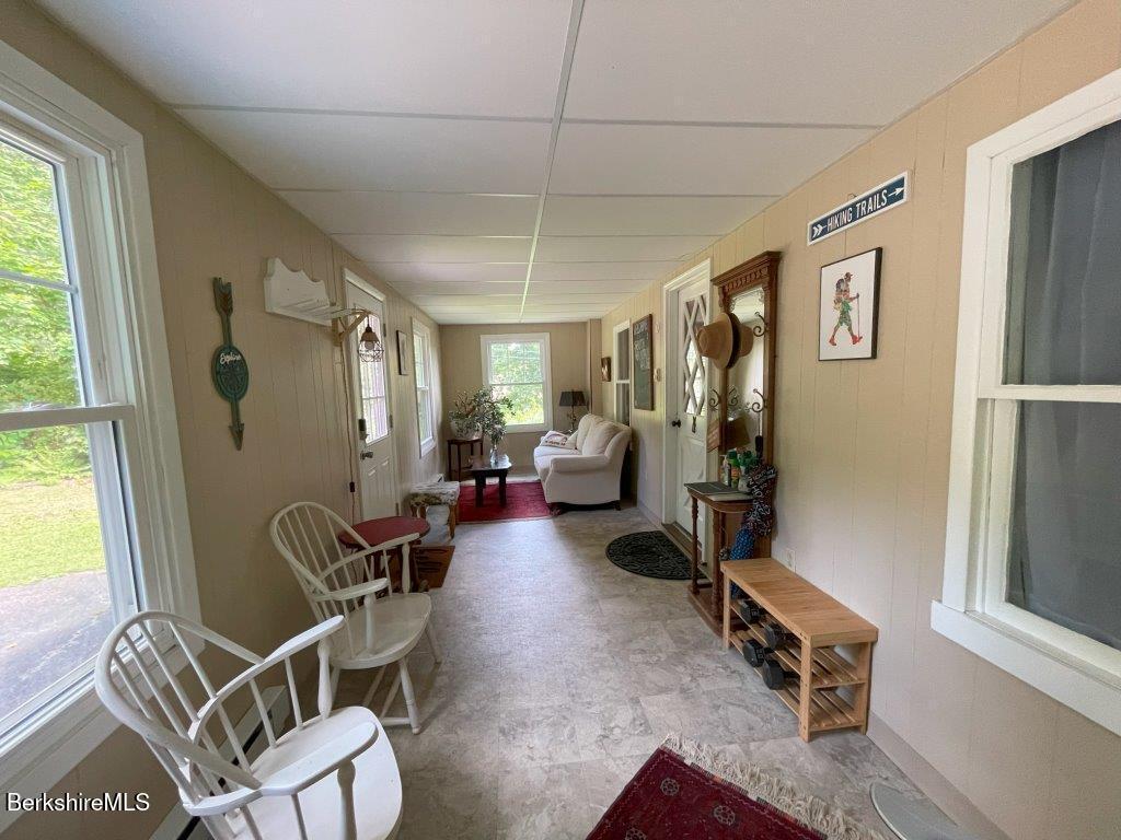 193 South Mountain Road Pittsfield, MA 01201 - Photo 5 of 49 a living room with furniture a window and gym equipment